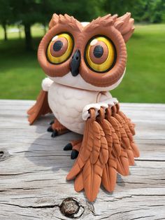 an owl statue sitting on top of a wooden table