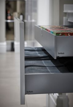 an electronic device is sitting on top of a shelf in a room with tile flooring