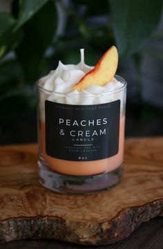 peaches and cream candle sitting on top of a wooden table