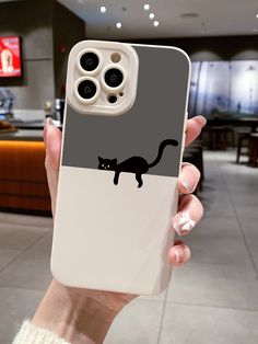 a person holding up a phone case with a cat on it