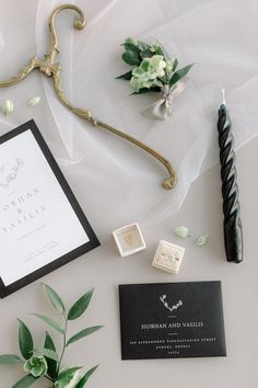 the wedding stationery is laid out on top of the table with flowers and candles