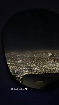 the view from an airplane window at night, looking down on a cityscape