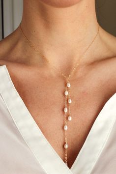 A customer favorite, this necklace is designed to be effortlessly chic. Simply drape over neck, cross in front and loop one end over the other, the elegant 5-6mm freshwater pearl tendrils will gracefully drape. It's a great twist on a classic pearl necklace...brides love it too! Closure: no clasp Materials: 14K Gold #jewelrynecklaces Bride Pearl Necklace, Classic Pearl Necklace, Elizabeth Jewelry, Tie Necklace, Minimal Jewelry, Sea Glass Jewelry, Necklace Designs, Wire Jewelry, Pearl Jewelry