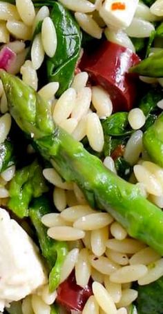 a salad with asparagus, chicken and white beans is shown in close up