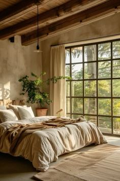 a large bed sitting in a bedroom next to a window with lots of light on it