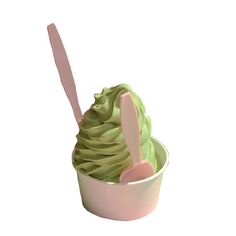 a scoop of green ice cream in a pink bowl with a spoon sticking out of it