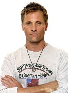 a man with his arms crossed wearing a shirt that says support our troops bring them home