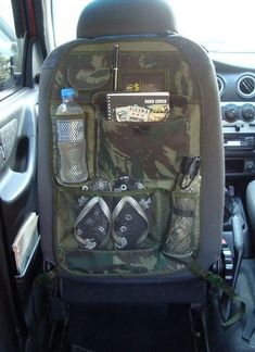 the back seat of a car with water bottles and other items in its pocket on it