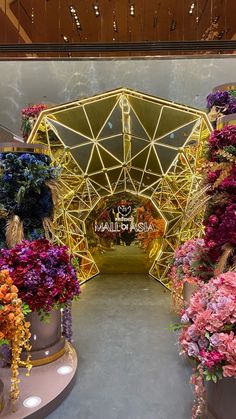 the inside of a flower shop filled with lots of different colored flowers and plants on display