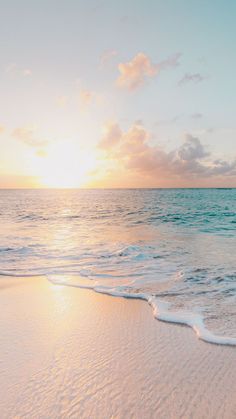 the sun is setting over the ocean with waves coming in to shore and green frame