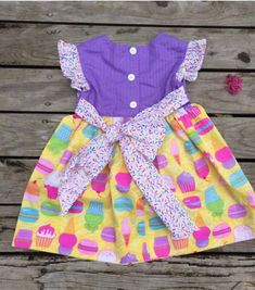 "Celebrate your little girl in this custom birthday dress! With a combination of sprinkle, cupcake, and ice creamTutti Fruitti fabrics you're sure to have a wonderfully colorful birthday! Choose Purple or Blue bodice color. Features: - Buttons up the back - Ties for a gorgeous bow - Flutter sleeves - Machine wash and dry - Appliqué or monogramming available - Size 12 mo to 8 girls. size , chest, waist, length, 12 months, 19\", 19\", 15.5\". 18 months, 20\", 19.5\", 17\" 2, 21\", 20\", 19.5. 3, 2 Fun Ruffle Dress For Birthday, Fun Ruffled Dresses For Birthdays, Fun Ruffled Dresses For Birthday, Playful Spring Birthday Twirl Dress, Cute Multicolor Dress For First Birthday, Cute Multicolor First Birthday Dress, Custom Birthday Dress, Sprinkle Birthday, Bug Dress