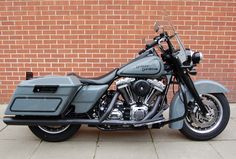 a motorcycle parked in front of a brick wall