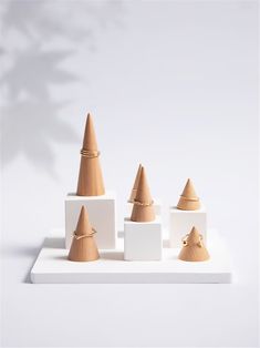 a group of wooden cones sitting on top of each other in front of a white background