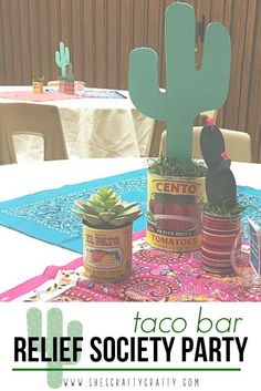 a table topped with lots of tin cans filled with food next to a cactus plant