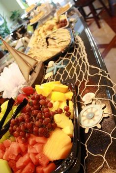 several trays filled with different types of fruit on a table in a hotel room