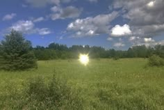 the sun shines brightly through the clouds over a field