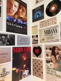 the wall is covered with posters and other items from various films, including an album