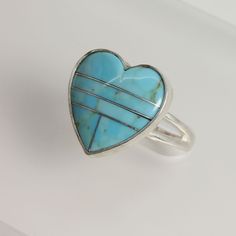 Turquoise Heart Ring in Sterling Silver Turquoise Heart Inlaid Cabochon, Heart Ring, Aqua Blue A beautiful turquoise ring that I designed, soldered and polished by hand. Featuring a Turquoise Inlaid Heart that I bezel set onto fine silver. Hand fabricated sterling silver ring has a split band towards the top. Top of ring measures 5/8 inch Custom Made by Lin Materials used to make this Custom Ring: ♦ .925 Sterling Silver and Fine Silver ♦ 16 X 16 MM Turquoise Inlaid Heart Cabochon Turquoise Heart Turquoise Gemstone Heart Ring For Anniversary, Heart-shaped Turquoise Ring For Anniversary, Handmade Blue Heart Shaped Ring, Handmade Blue Heart Ring, Heart-shaped Turquoise Blue Ring For Gift, Heart-shaped Blue Turquoise Ring Gift, Heart-shaped Blue Turquoise Ring For Gift, Turquoise Inlay Rings As A Gift, Heart-shaped Turquoise Ring As Gift