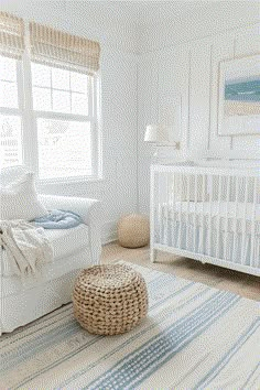 a baby's room with white furniture and blue accents