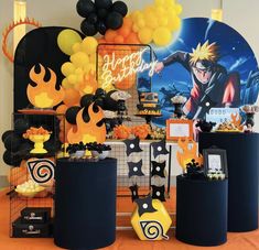 a birthday party with balloons and decorations on the table, including an anime character balloon centerpiece