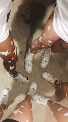 several people with white stars painted on their legs