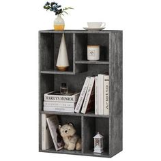 a book shelf with books and a teddy bear on it's side, against a white background