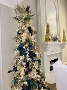 a christmas tree decorated with gold and silver decorations