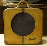 an old yellow suitcase sitting on top of a table