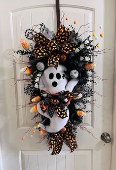 a halloween wreath hanging on the front door