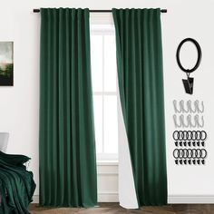 a green curtain hanging on the side of a window next to a chair and wall