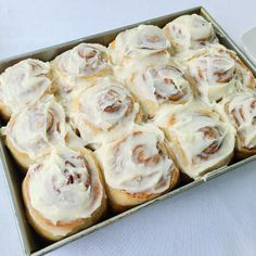 a pan filled with cinnamon rolls sitting on top of a table