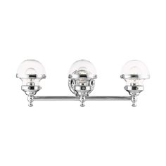 three light bathroom fixture with clear glass globes on the sides and chrome metal arms