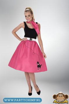 a woman in a pink skirt and black top with a poodle on the waist