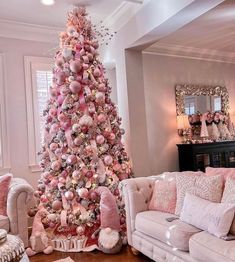 a pink christmas tree in a living room