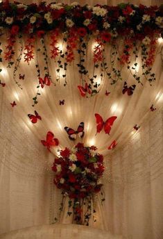 the curtains are decorated with flowers and butterflies on them, along with lights in the background