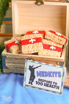 some food is in a wooden box on a table with a sign that says med kits restore to health