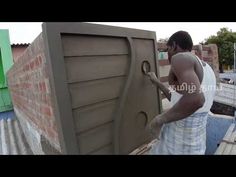 a man is working on the side of a building