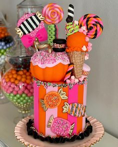 a cake made to look like an ice cream cone with candies and lollipops