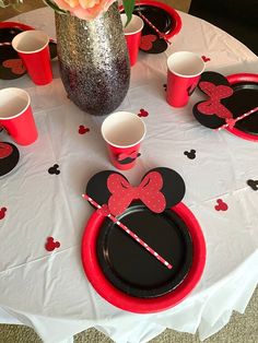 a table with mickey mouse plates and cups