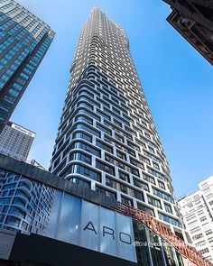 an upward view of the arq building in new york's financial district, looking up at it