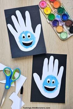 two handprints are shown with scissors and paint