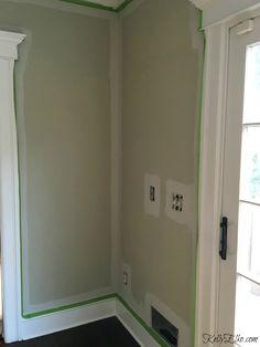 an empty room with green trim on the walls