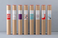 six yoga mats lined up next to each other in front of a gray background with red and white stickers on them