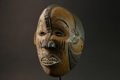 an african mask is displayed on a stand