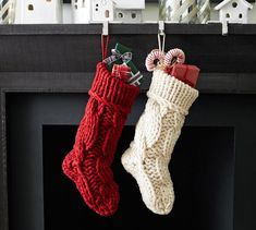 two knit stockings hanging from a fireplace mantel