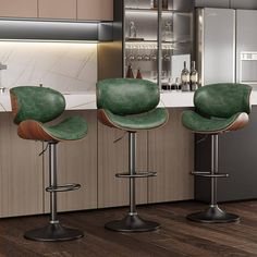 three green bar stools sitting in front of a kitchen counter