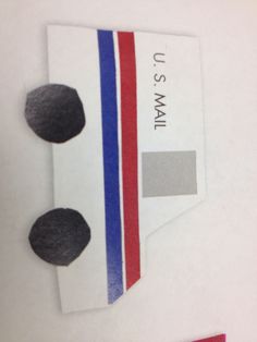 a piece of paper that has been cut out to look like a flag and some black rocks