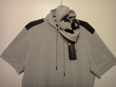 a grey hoodie with a tag hanging from it