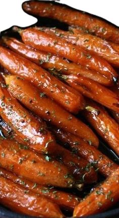 cooked carrots in a pan with seasoning on top