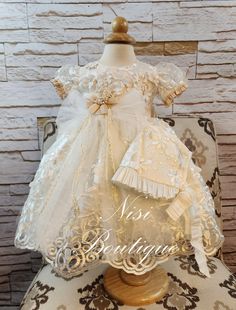 "★Beautiful Ivory Christening Gown, Baptism Dress★ ★Occasion: Baptism, Child Blessing or any Special Occasion ★Comes With: Dress, Bonnet and dress Bag ★Measurements 6-9 Months, (Long 20\") (Waist 18\")  (Shoulder to Shoulder 8\") 9-12 Months, (Long 23\") (Waist 20\")  (Shoulder to Shoulder 8.5\") 12-18 Months, (Long 24\") (Waist 21\")  (Shoulder to Shoulder 9\") -Waist measurement is around ★Features: The back of the dress has ties for greater comfort when the girls put it on. (The waist is adjustable, has two ribbons to make a bow, as in the photo) The measurements are approximate, they can change a little bit. Please check the measurements in the last picture, and any questions or more photos of any particular size send me a message, your satisfaction is very important for me. Comes with Fitted Cream Dress For Pageant, Cream Ruffled First Communion Dress For Baptism, Cream Ruffled Gown For Baptism, Cream Baptism Dress With Ruffles For Pageant, Pageant Baptism Dress In Cream With Ruffles, Cream Baptism Dress For Ceremony, Fitted Cream First Communion Dress With Ruffles, Cream Ruffled Baptism Dress, Fitted Cream Gown For Pageant